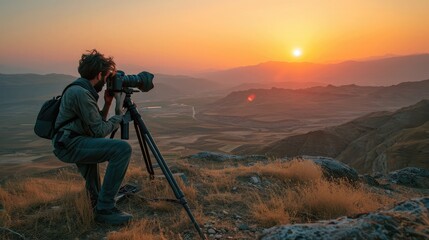 Filmmaker overlooking valley sunset
