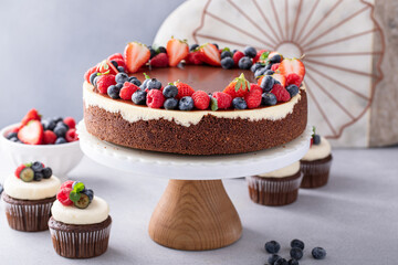Chocolate and vanilla cheesecake topped with chocolate ganache and fresh berries