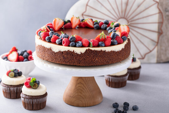 Chocolate and vanilla cheesecake topped with chocolate ganache and fresh berries