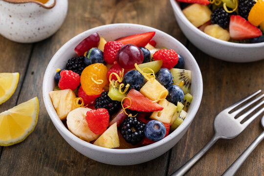 Healthy And Colorful Fruit Salad With Orange Dressing And Fresh Mint