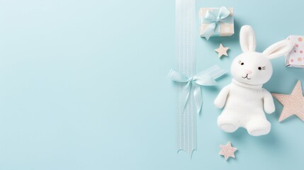 Sweet Baby Accessories on Pastel Blue Background - Knitted Bunny, Rattle Toy, and More!