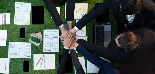 Business synergy in panoramic top view banner of business people holding hand together as team...
