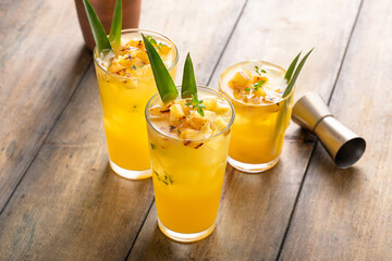 Grilled pineapple cocktail or mocktail garnished with pineapple leaves