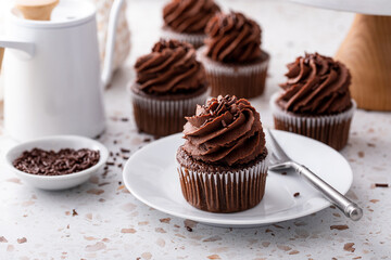 Chocolate cupcakes topped with whipped chocolate ganache