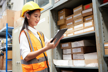 factory worker holding a clipboard and checking a products on shelf in warehouse storage