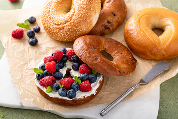 Cinnamon raisin bagel topped with cream cheese and fresh berries