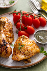 Roasted chicken thighs and drumsticks served with pesto sauce