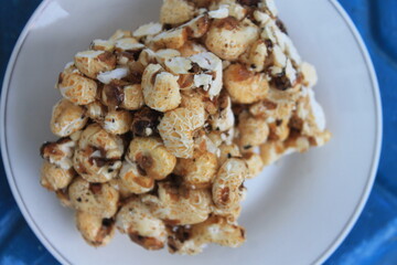 Indonesian snack called brondong made of corn in a white plate on the table