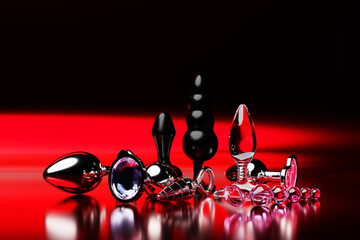 Set of the  butt anal plugs sex toys on   red isolated background. 3D illustration. Empty space for...