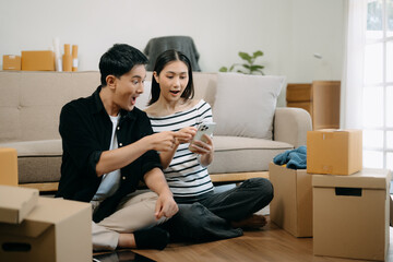 Happy asian young attractive couple man and woman with big boxes moving into a new house, new apartment for couple the new home, Moving house.