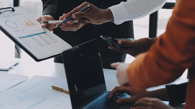 Close-up asia business people meeting plan analysis statistics brainstorm and header of team hold tablet pointing graph chart and employee take note. Finance strategy statistics success concept.