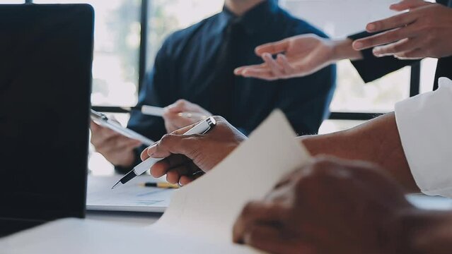 Close-up asia business people meeting plan analysis statistics brainstorm and header of team hold tablet pointing graph chart and employee take note. Finance strategy statistics success concept.