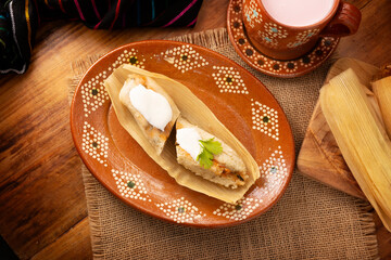 Tamales. hispanic dish typical of Mexico and some Latin American countries. Corn dough wrapped in corn leaves. The tamales are steamed.