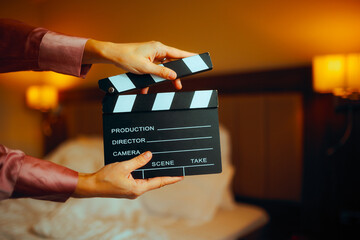 Hand Holding a Film Slate in a Bedroom. Director making an independent motion picture with limited budget
 - obrazy, fototapety, plakaty