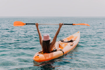 Woman sea kayak. Happy smiling woman paddling in kayak on ocean. Calm sea water and horizon in background. Active lifestyle at sea. Summer vacation.