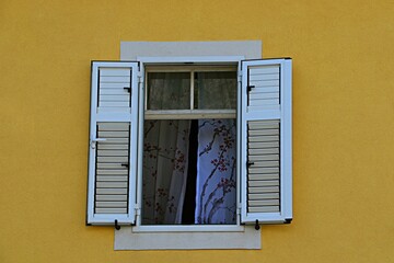 Open window on a yellow wall