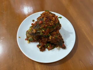 Indonesian traditional dish named Ikan Tuna Balado which is made from fried tuna fish with chili, garlic, shallot and other spices