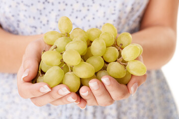 Health, hands and closeup of woman with grapes in a studio for detox, vegan diet and fresh ingredient. Wellness, nutrition and zoom of female model with organic fruit for vitamins by white background
