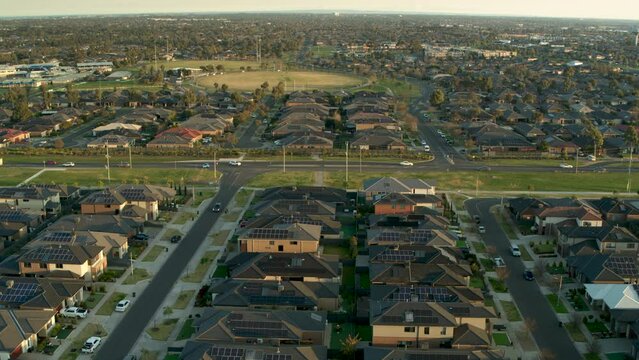 Aerial flyover of suburban streets and horizon
