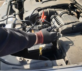 A man is checking a car battery