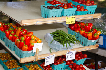 Farm fresh vegetables for sale an an outdoor farmers market.