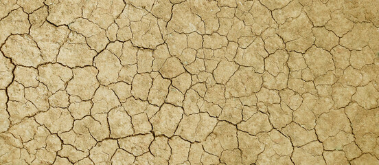 Cracked ground background in the top view for graphic design or wallpaper