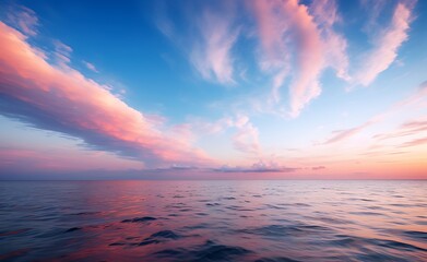 Beautiful sunset over the sea with clouds and sky reflected in water