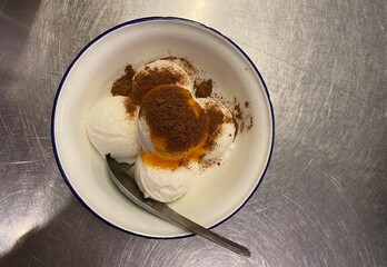 Coops of ice cream served on top egg yolk and chocolate 