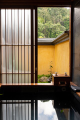 Japanese hot spring bathroom with boiling water for rest and relax when open wooden window for get some fresh air and garden view in traditional ryokan home