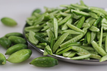 Heap of Ivy gourd or Kovaka vegetables, meticulously sliced lengthwise.
