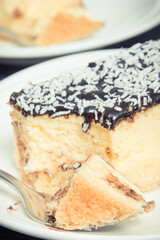 Portion of fresh baked cheesecake on plate. Delicious dessert