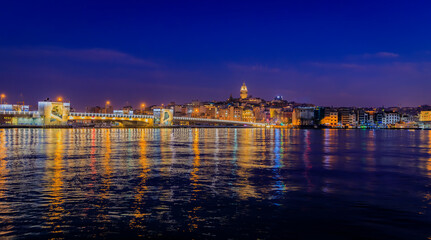 Fototapeta premium Sunrise cityscape of the Karakoy area across the Bosphorus Strait near Galata Bridge with the Galata Tower at the blue hour in Istanbul, Turkey