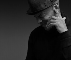 deafness suffering from hearing loss on grey black background with people stock image stock photo	