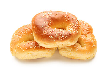 Tasty bagels with sesame seeds on white background