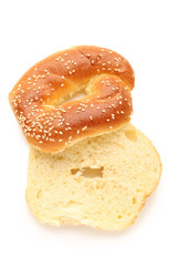 Fototapeta premium Halves of tasty bagel with sesame seeds on white background