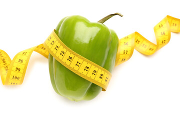 Bell pepper and yellow measuring tape on white background. Diet concept