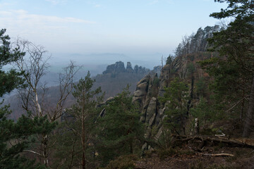 Fototapeta na wymiar An early morning in mountain. Schrammsteine - group of rocks are a long, strung-out, very jagged in the Elbe Sandstone Mountains located in Saxon Switzerland in East Germany.