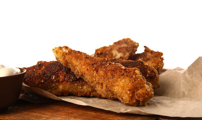 Wooden board of tasty fried codfish on white background, closeup