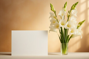 A bouquet of white gladioli flowers and an empty white postcard with an empty place for the inscription