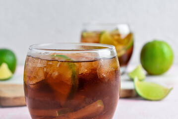 Glass of cold Cuba Libre cocktail on table