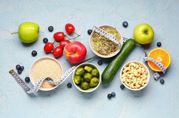 Composition with healthy food and measuring tape on blue grunge background. Diet concept