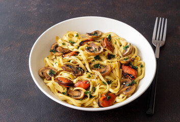 Tagliatelle pasta with mussels and mushrooms. Italian cuisine. Seafood.