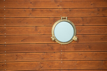 Round window in a wooden boat.
