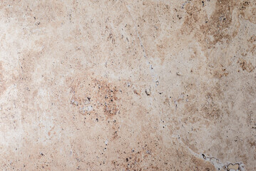 The background is beige and brown stone