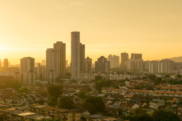 Obraz premium condos towering over terrace houses at sunset