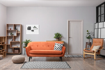 Interior of living room with pegboard, sofa and armchair