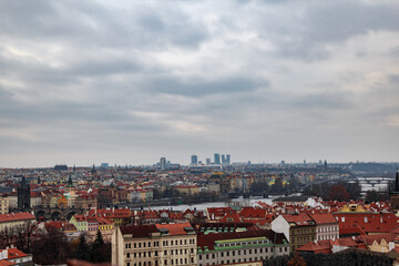 Fototapeta na wymiar Panoramic view of the medieval city Prague during winter. You can the Charles bridge and skycrapers in the distance. The wather was cloudy