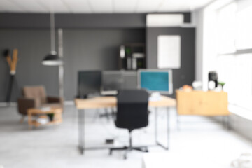Blurred view of modern office with computers