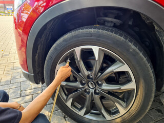 The driver inflates the car's tires with nitrogen. concept of measuring car tire pressure.