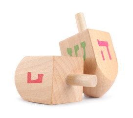 Hanukkah celebration. Wooden dreidels with jewish letters isolated on white
